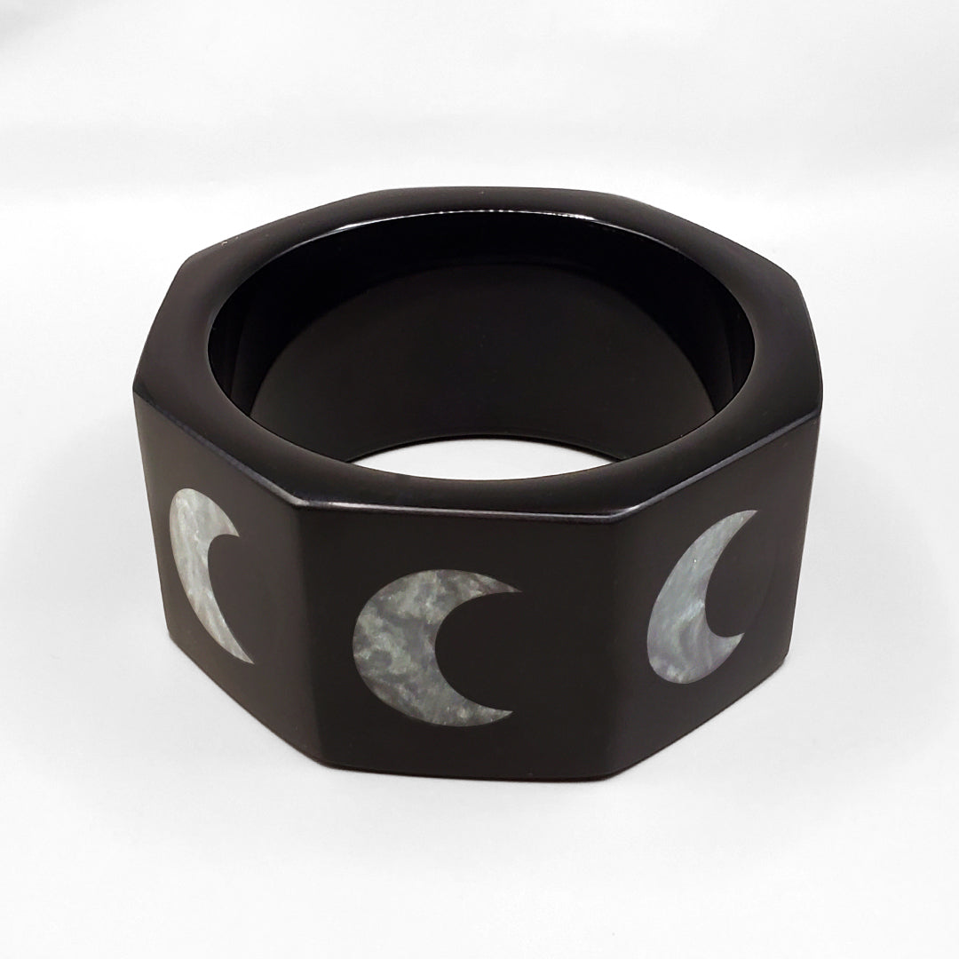 BLACK OCTAGON INLAID WITH SILVERY CRESCENT MOONS